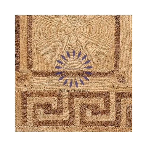Handwoven natural abaca jute rug with geometric design - large spiral circle on top and Greek key pattern on bottom in natural tan and brown tones, showing detailed coiled fiber texture.