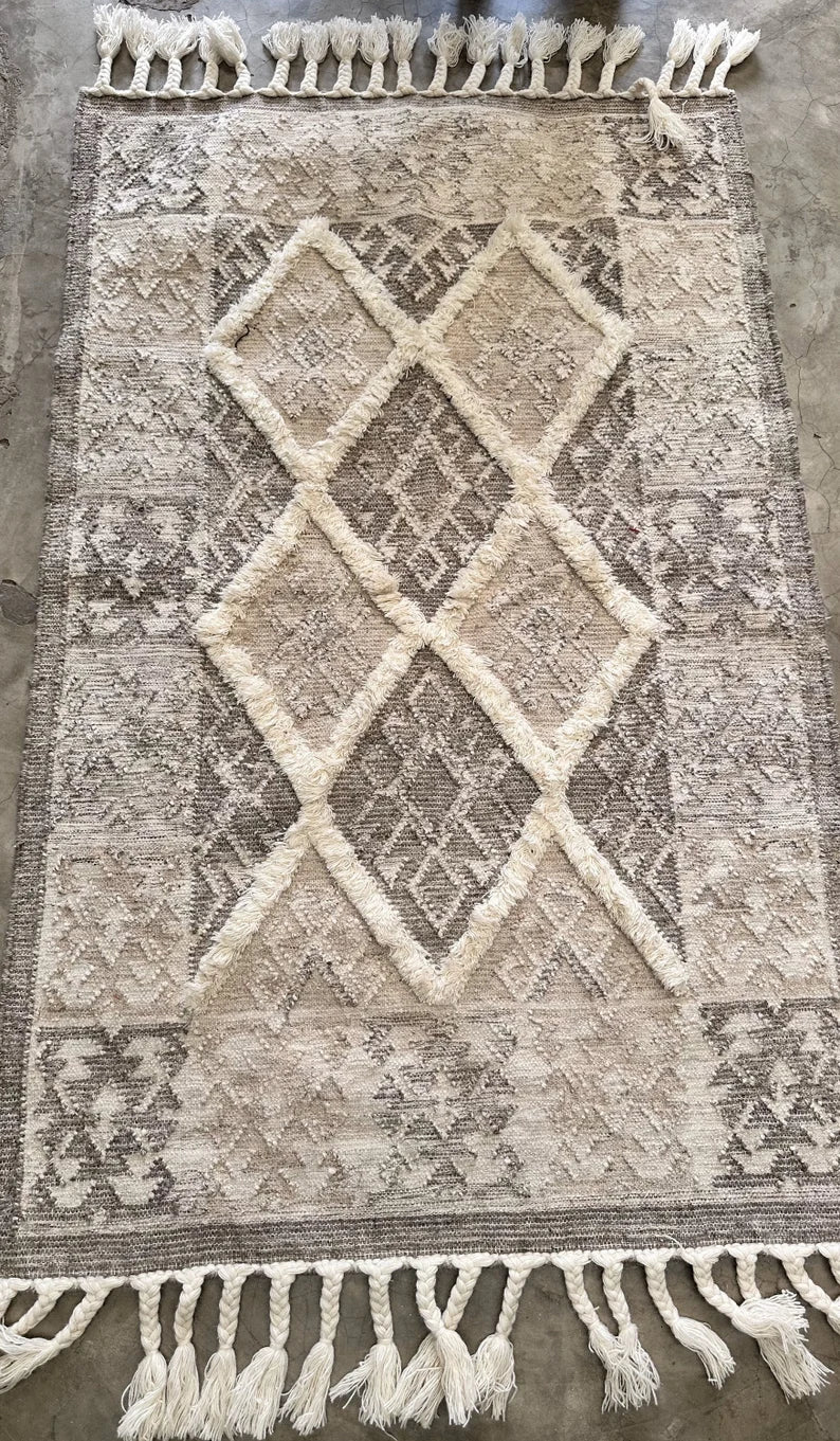 Cream and gray handmade geometric rug with tassel fringe