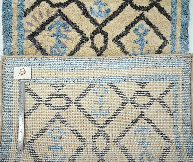 Hand-knotted vs hand-tufted backing detail - nautical anchor motif wool rug - front plush pile and back woven construction with scale ruler - Moroccan coastal rug
